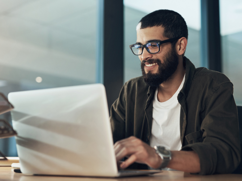 man on laptop researching ecommerce customer service software