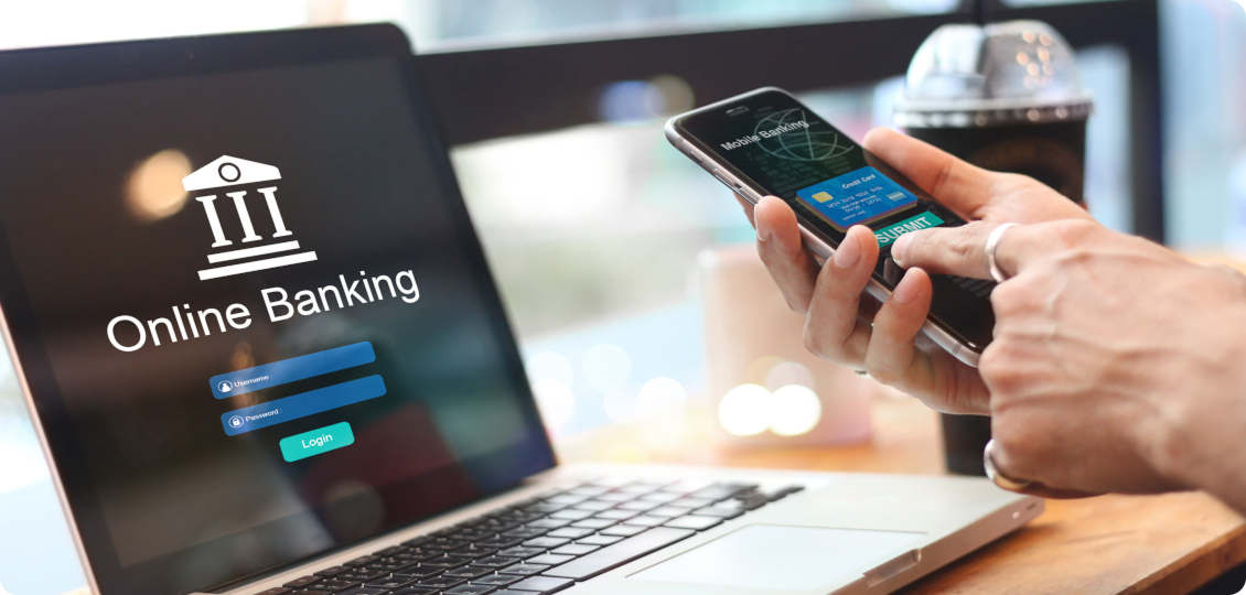 Someone online banking on mobile and laptop