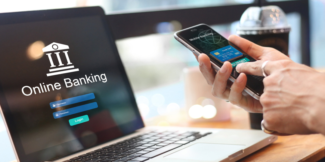 Someone online banking on mobile and laptop