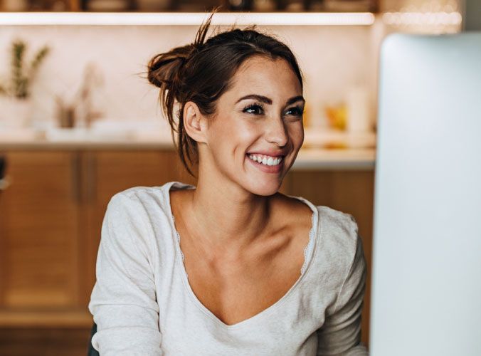 Woman smiling at computer