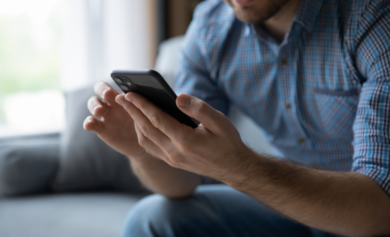 Someone typing on their smartphone