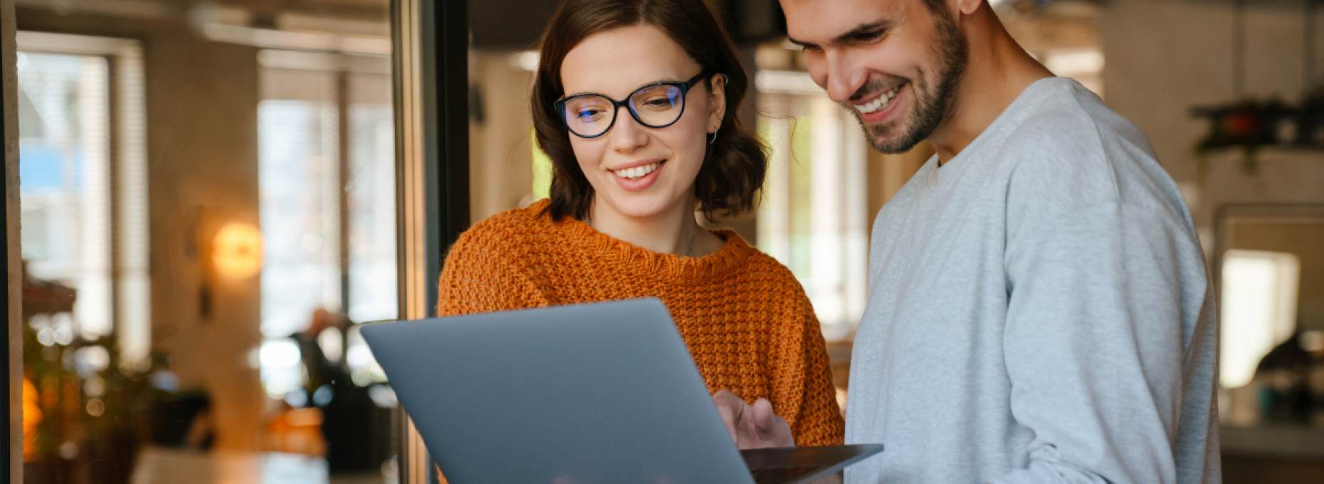 Two coworkers, man and woman, working on laptop