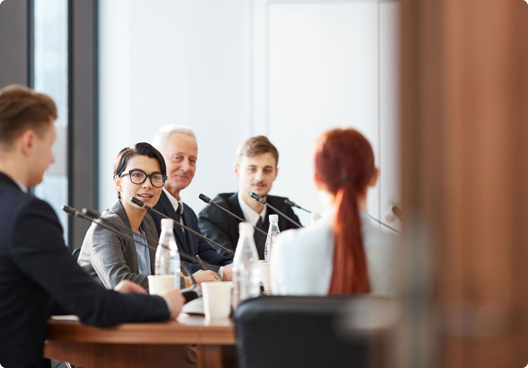 A group of people having a meeting in a conference room