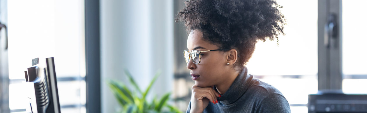 Woman with glasses using her computer