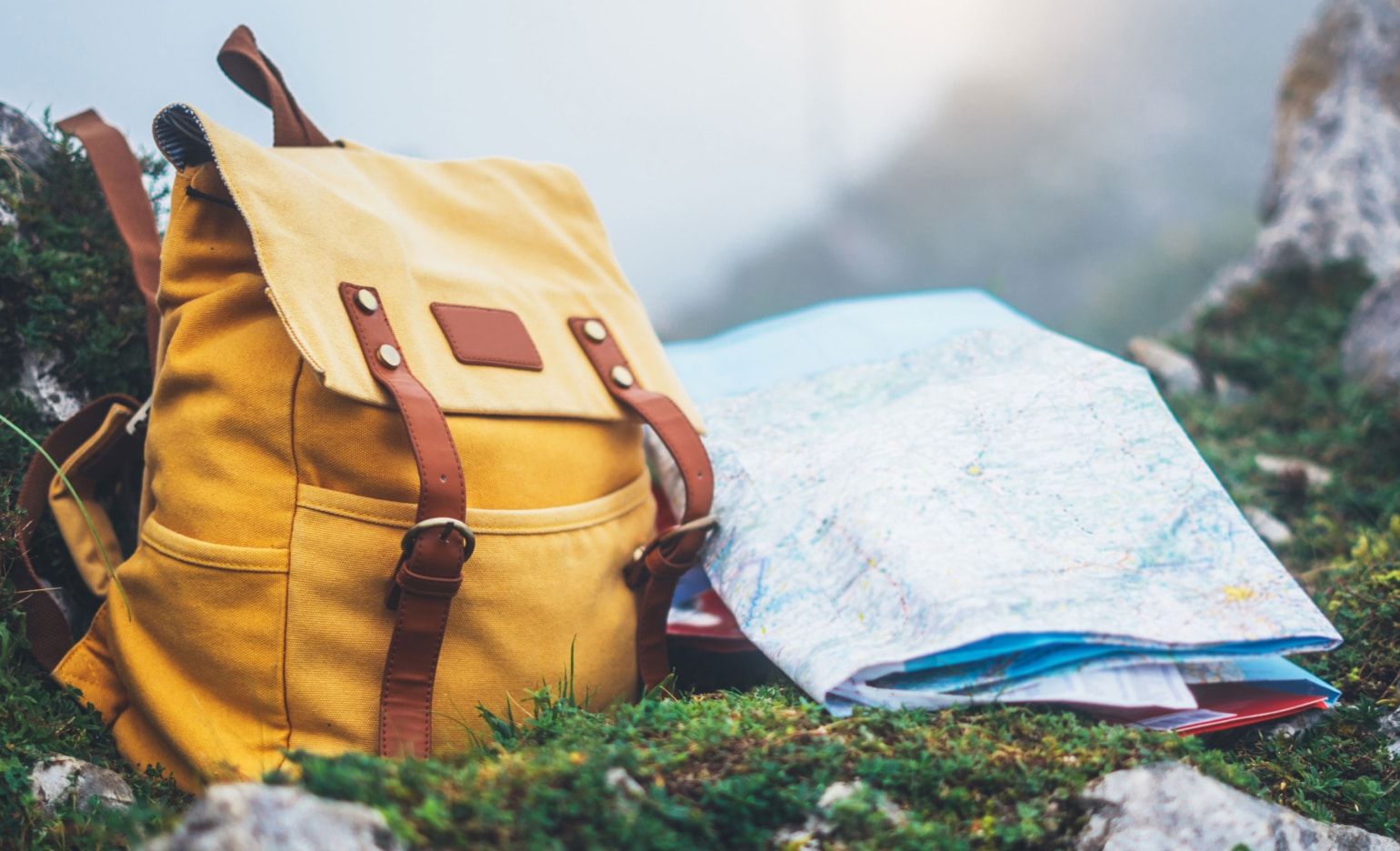 Photo of a backpack and map, signifying a journey — to great CX!
