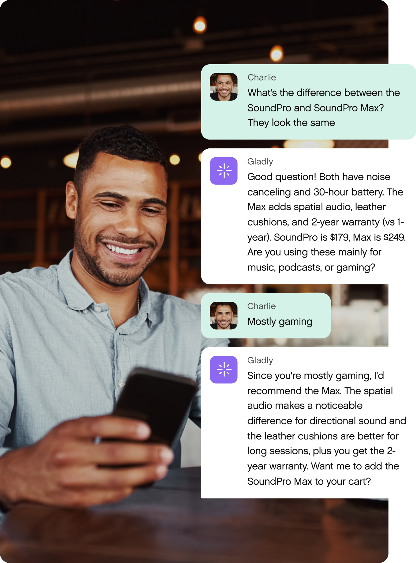 A man smiles while holding a phone, engaged in text conversation about choosing between SoundPro and SoundPro Max headphones for gaming.