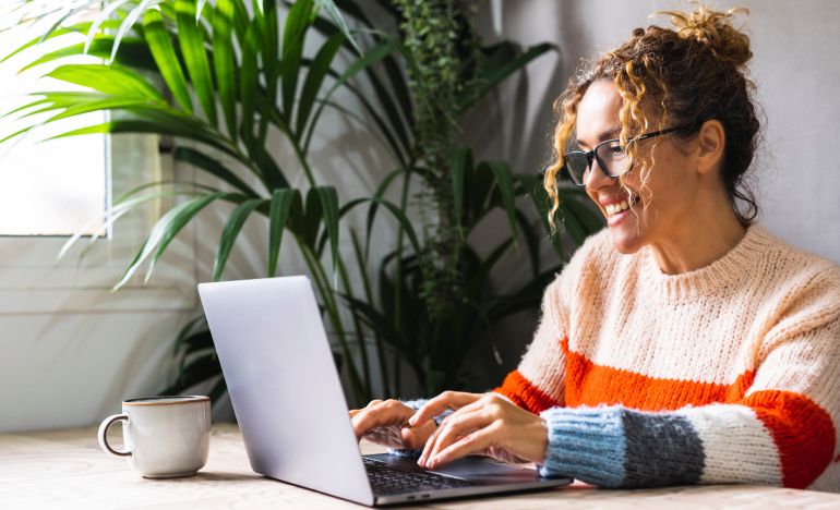 A CX expert who is happy to be upgrading her legacy CX systems on her laptop