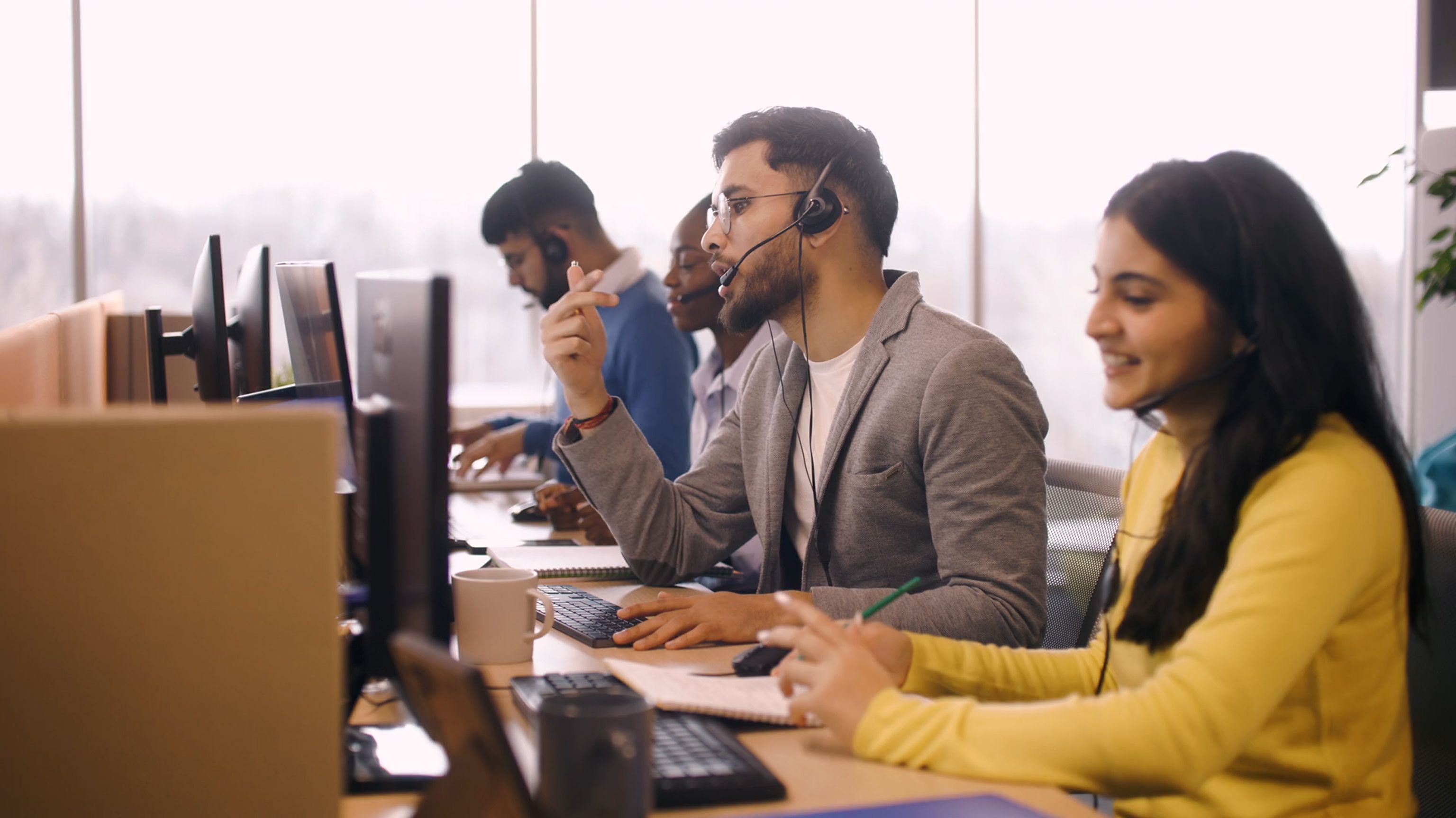 Group of happy and engaged customer service reps at work