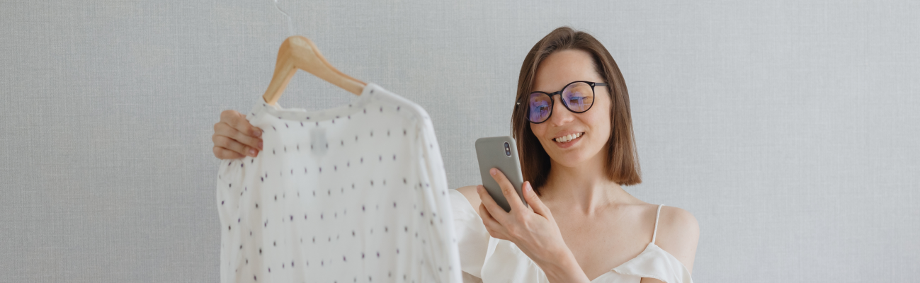 Woman taking a picture of a blouse with her smartphone