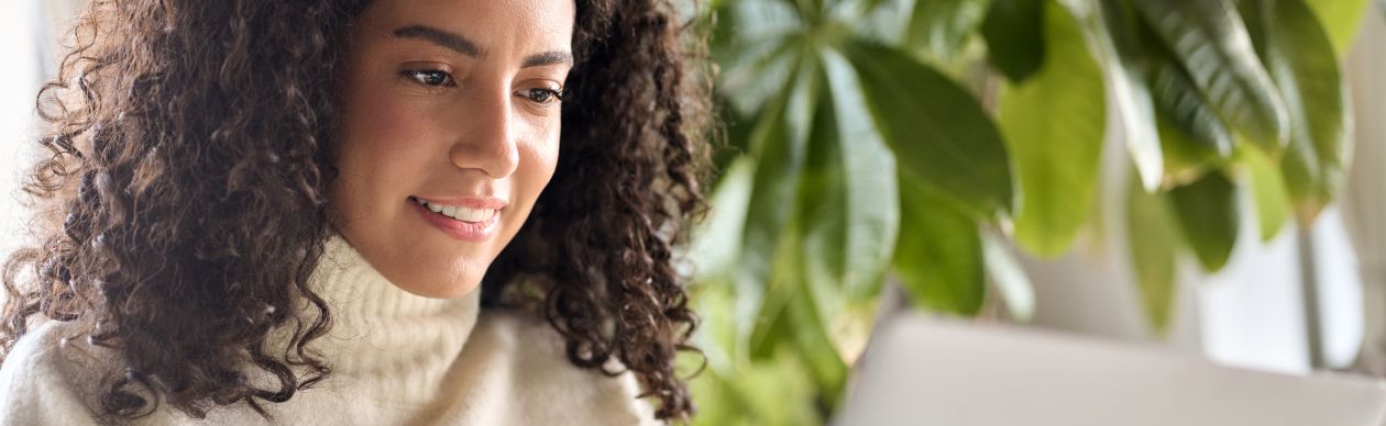 a woman researching gladly g2 customer service results on her laptop