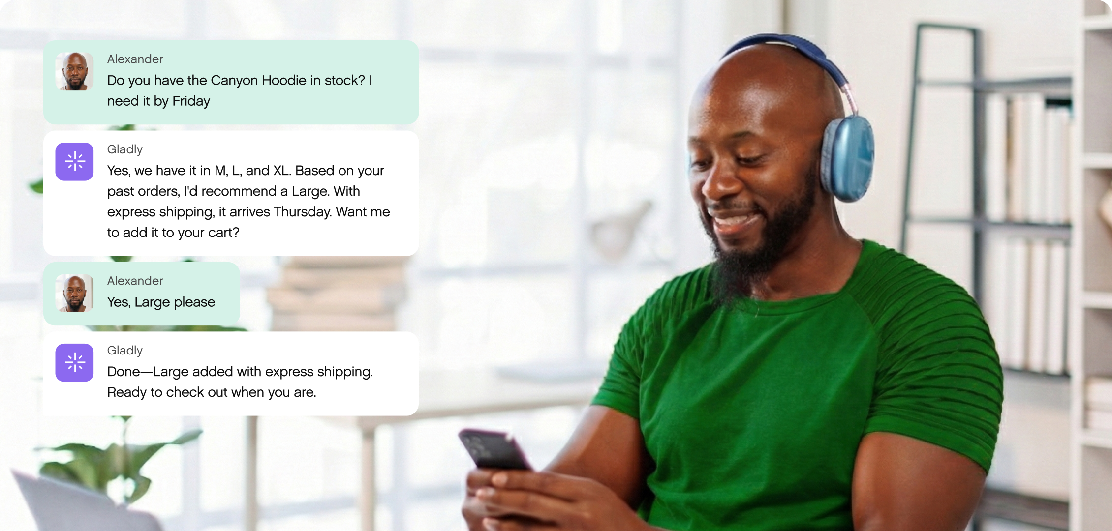 Man wearing headphones smiles at phone, engaging in a text chat. Conversation about ordering a hoodie. Modern workspace with books in the background.