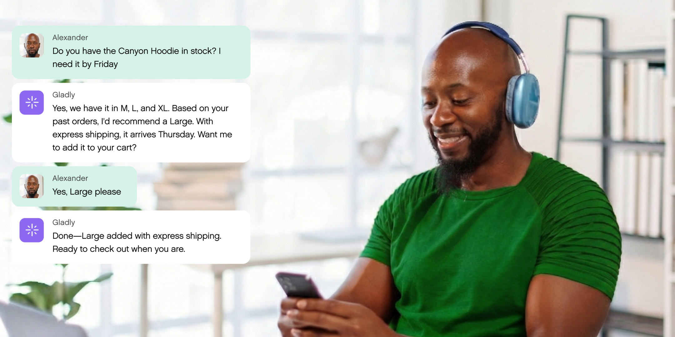 Man wearing headphones smiles at phone, engaging in a text chat. Conversation about ordering a hoodie. Modern workspace with books in the background.