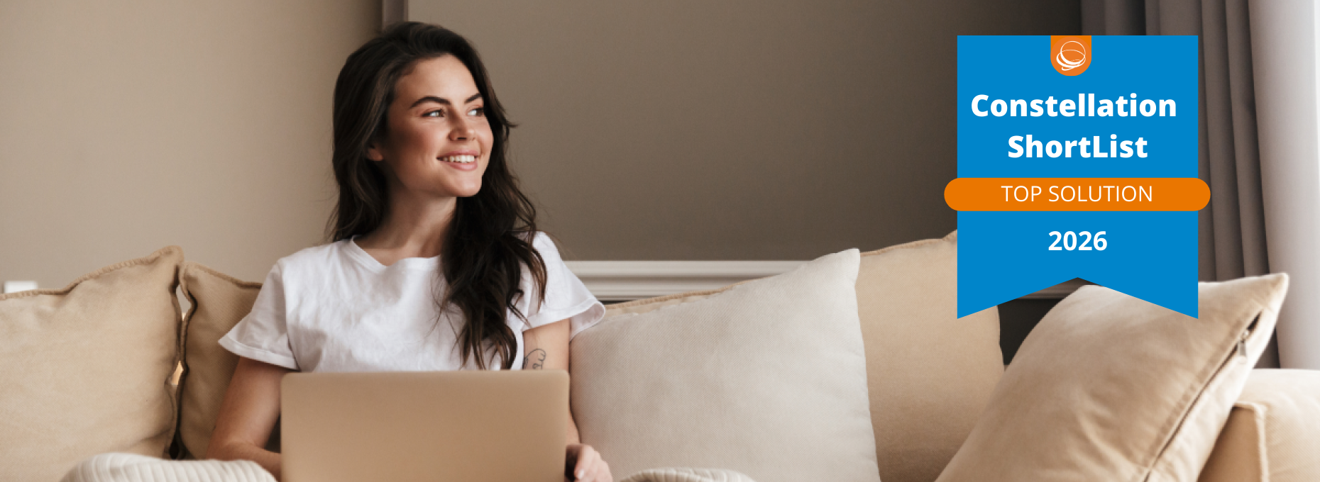 Woman smiling at laptop with Constellation ShortList 2026 Top Solution badge