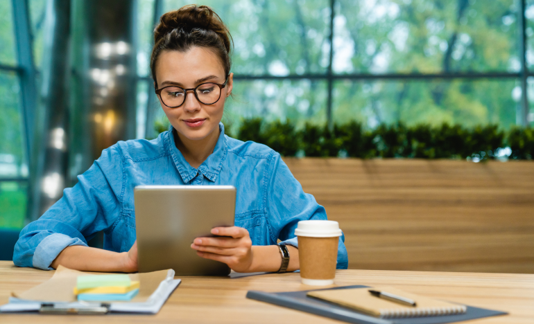 Woman wearing glasses using her Tablet