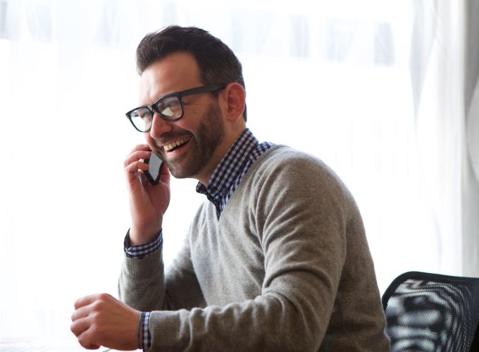 Man speaking with AI voice agent on phone