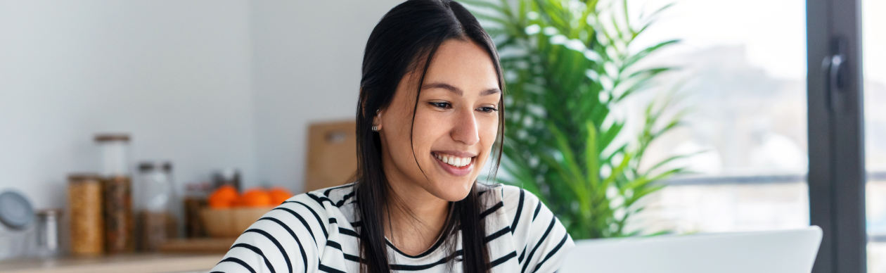 Woman smiling while using laptop