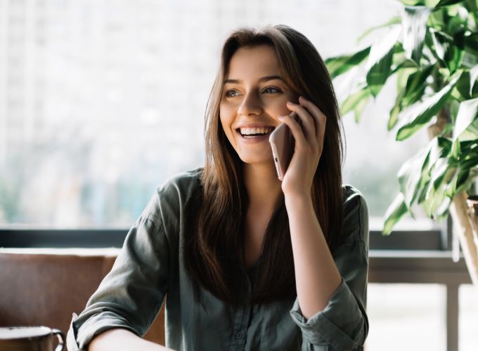 Woman speaking on phone with AI agent Sidekick Voice from Gladly
