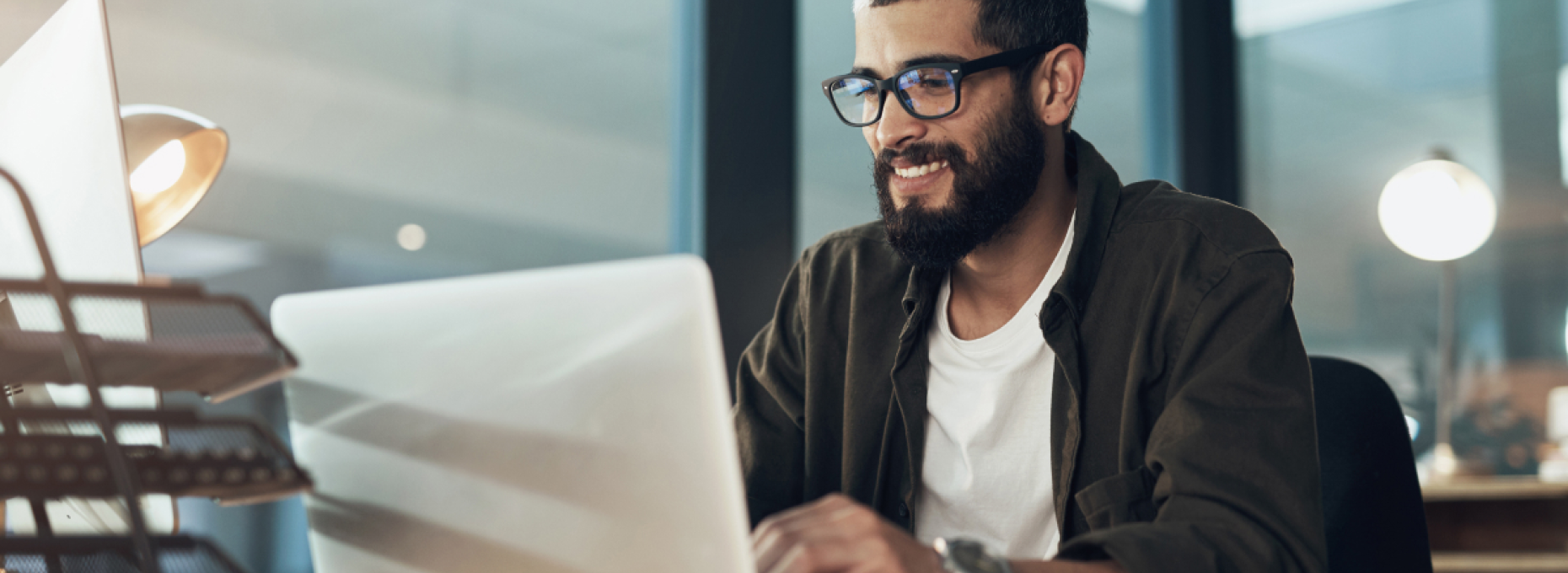 man on laptop researching ecommerce customer service software
