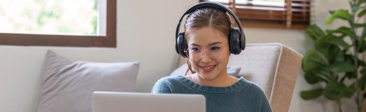 Woman taking notes off the information from her laptop