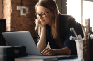 Woman smiling at a laptop