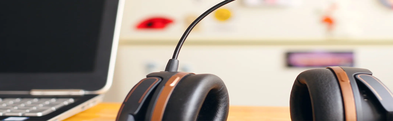 Headphones next to a laptop