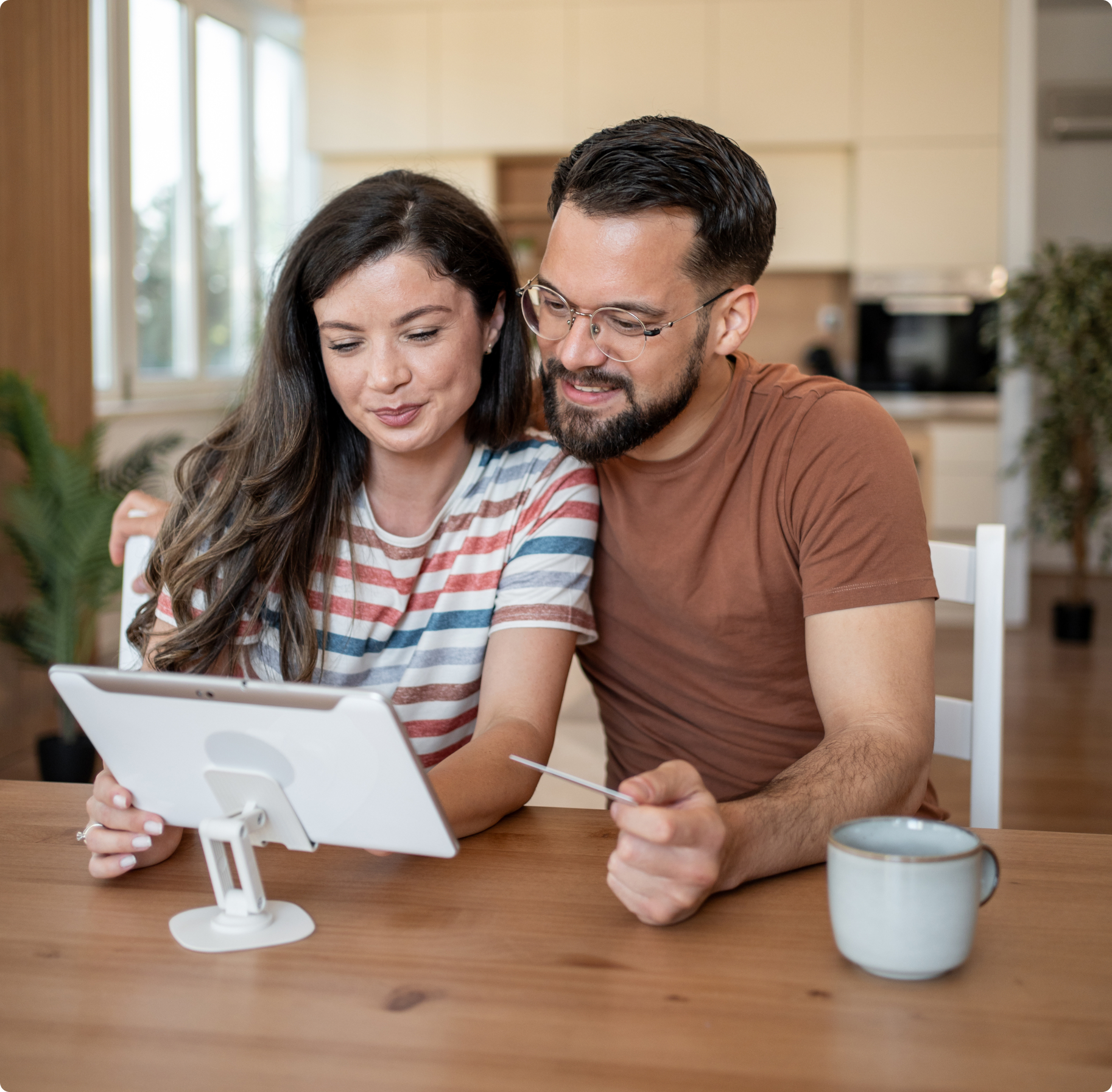 Couple doing online banking in the kitchen