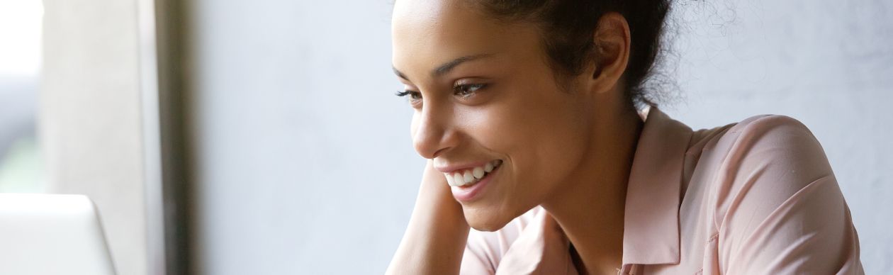 Woman smiling at her laptop