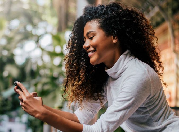 Woman smiling at cellphone
