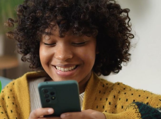 Woman smiling at her phone
