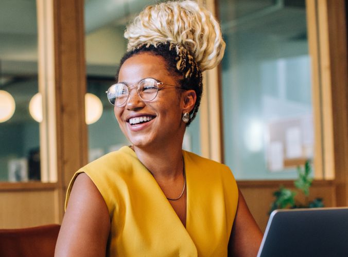 Woman smiling while using laptop