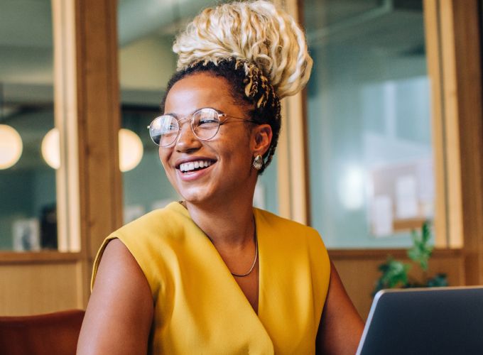 Woman smiling while using laptop