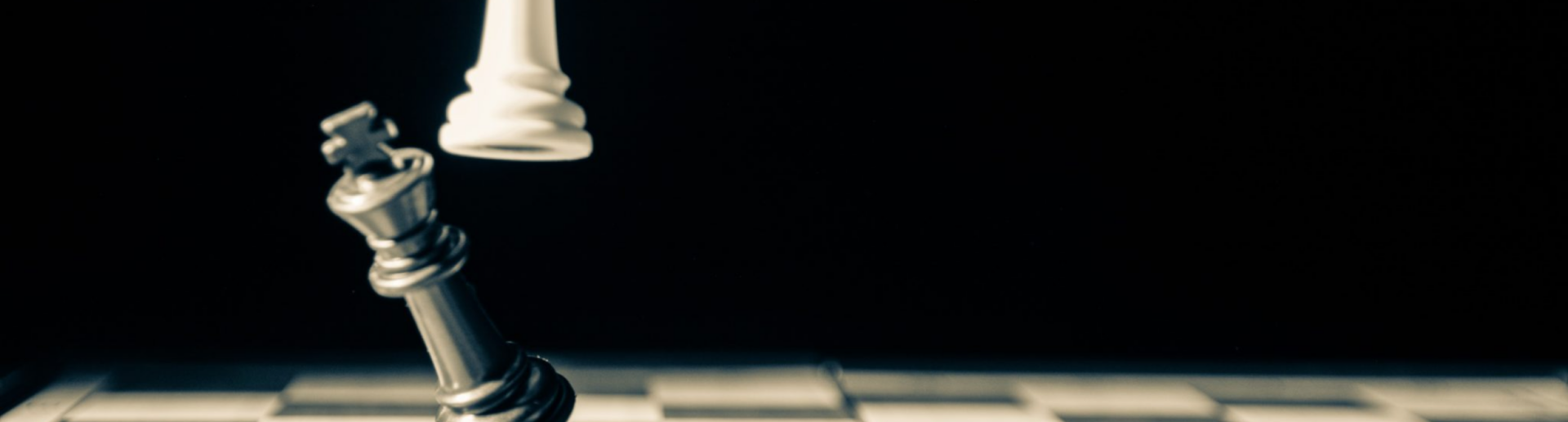 Image of a white chess piece knocking over a black chess piece