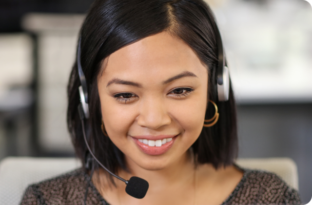 Woman smiling and wearing a phone headset