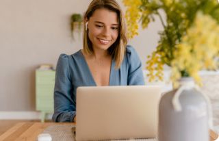 Woman smiling at a laptop