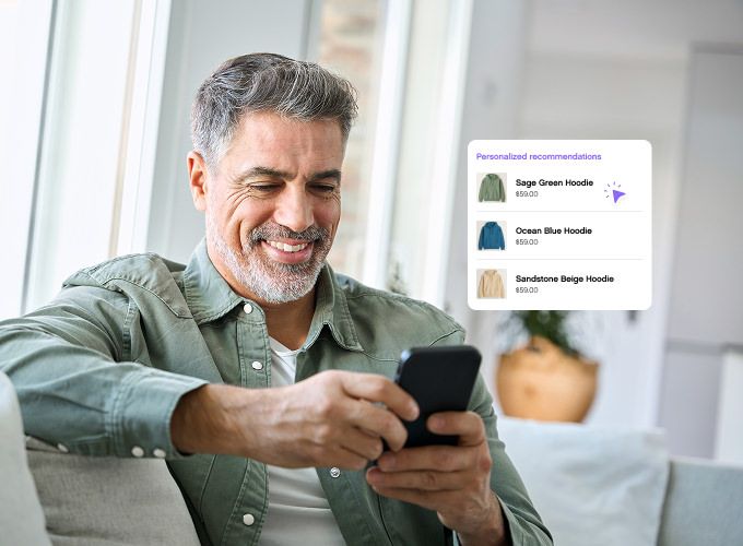 Man sitting down looking at phone smiling
