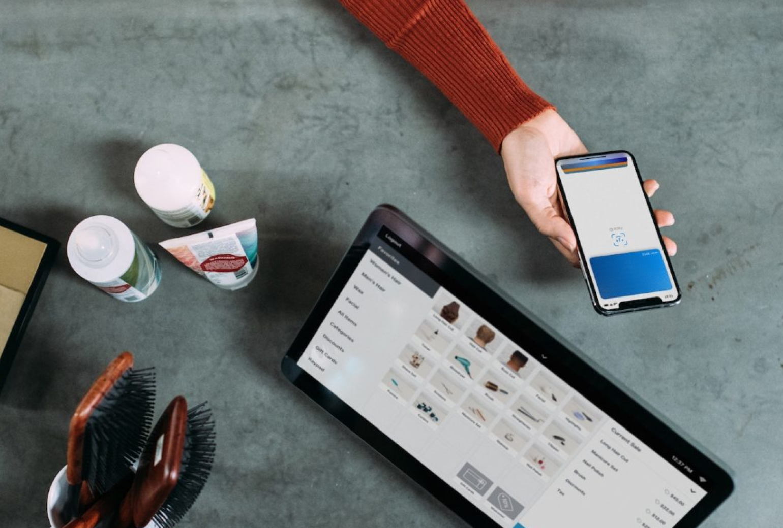 Someone holding out their smartphone to pay for a purchase