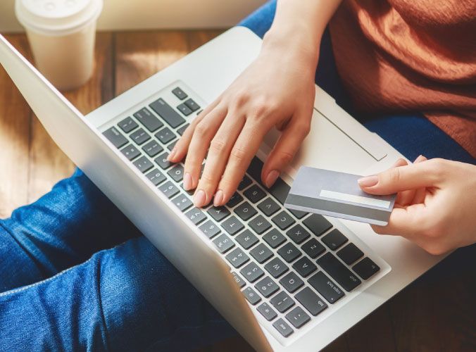 Person on a laptop using a credit card