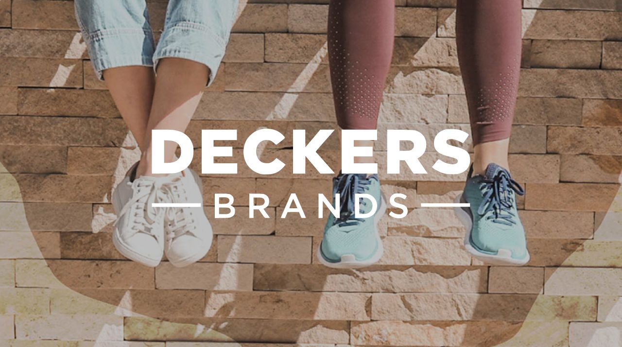 Deckers Brands logo over seated people hanging their feet off a wall wearing Deckers shoes