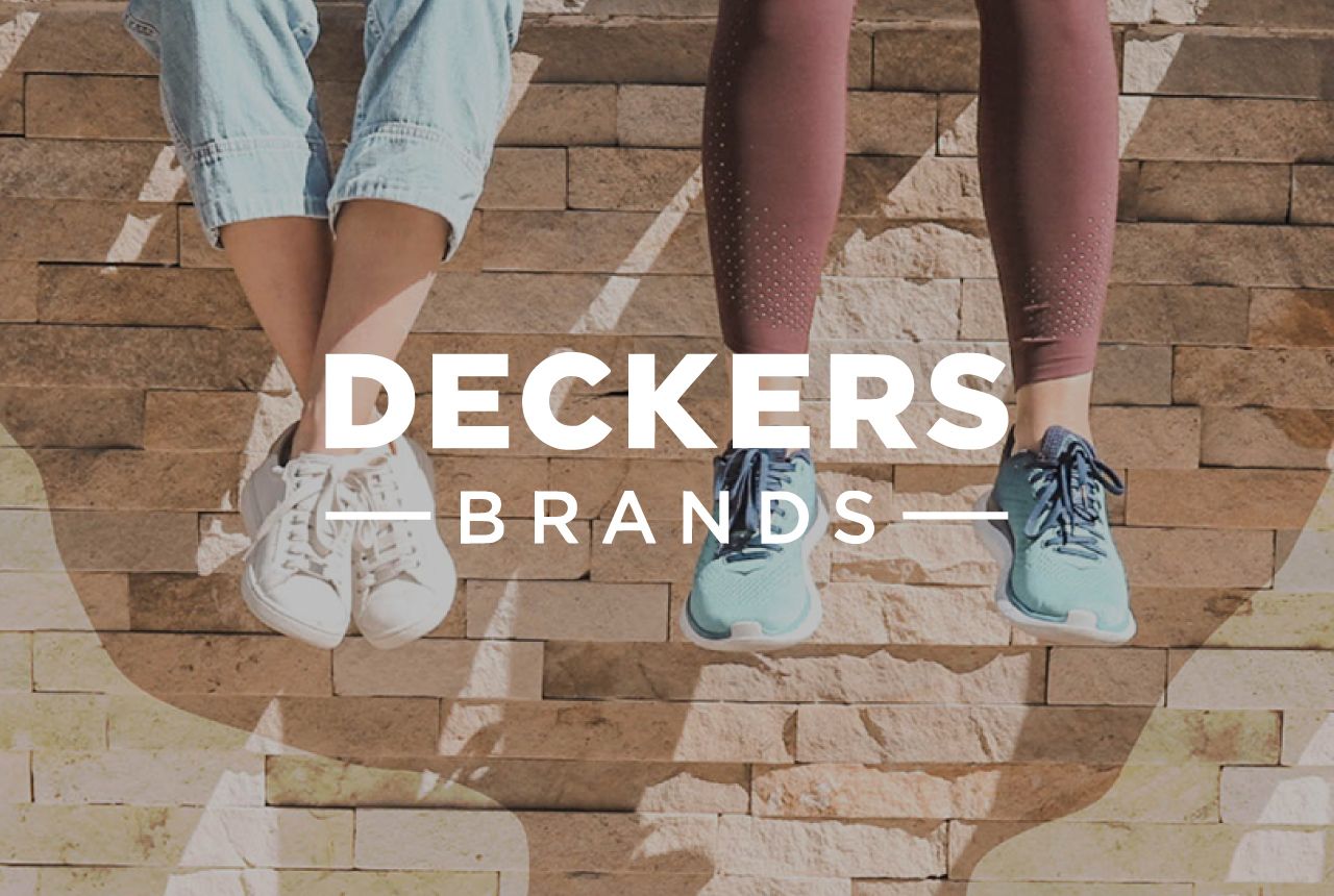 Deckers Brands logo over seated people hanging their feet off a wall wearing Deckers shoes