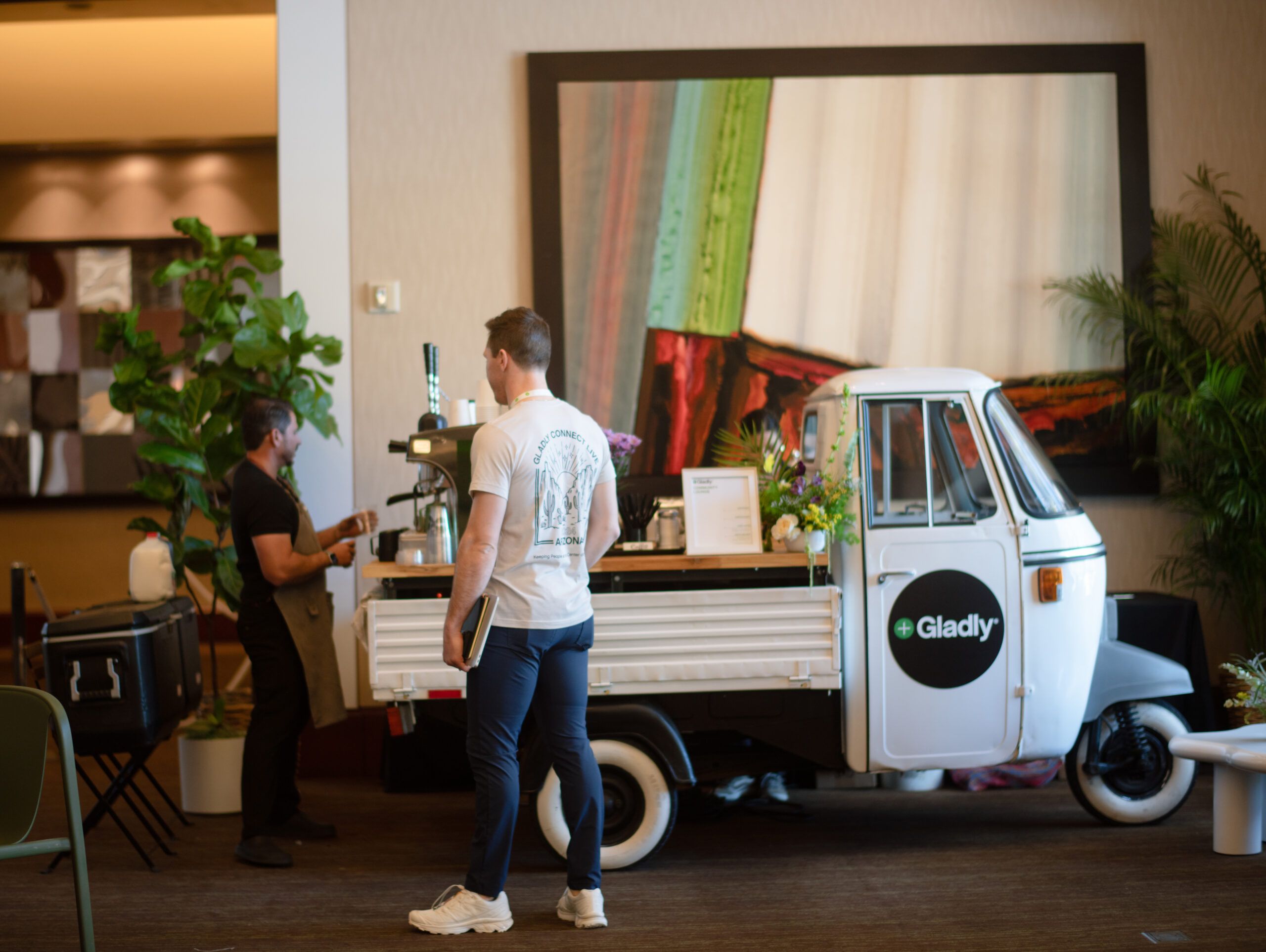 A person getting a drink from a Gladly drink truck