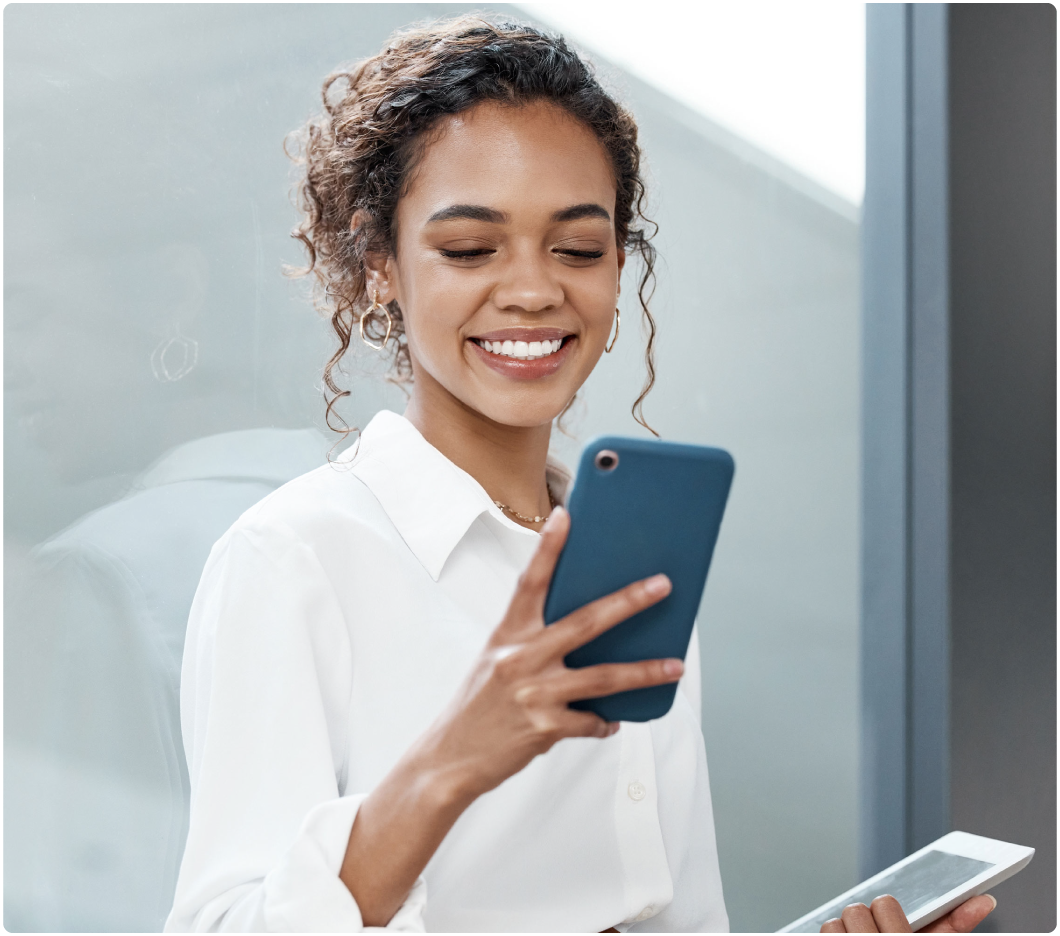 Woman smiling at her blue smartphone