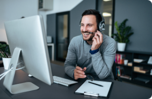 Man wearing headset at desktop computer
