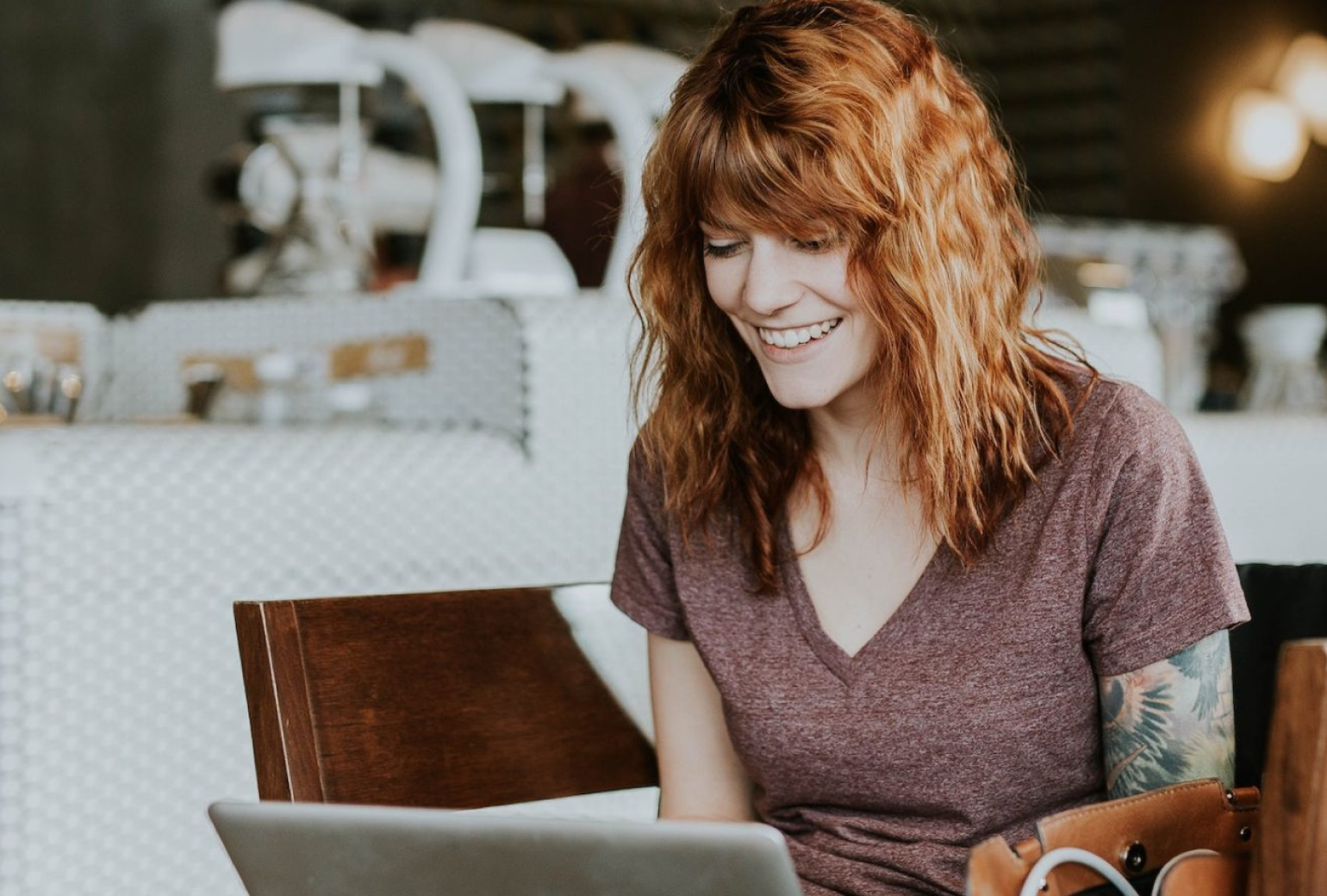 Woman smiling at a laptop