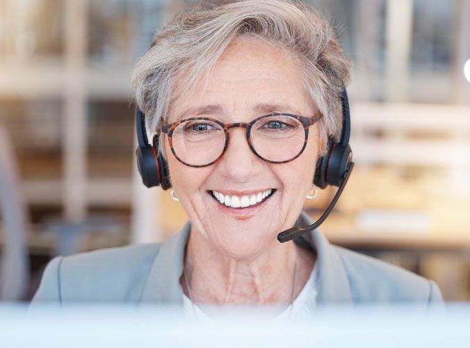 Older customer service agent smiling