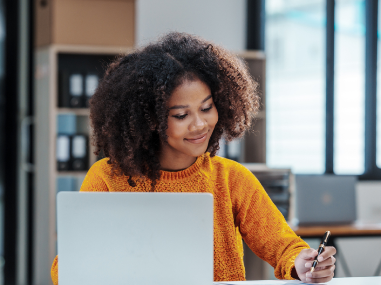 Woman working contentedly on her laptop
