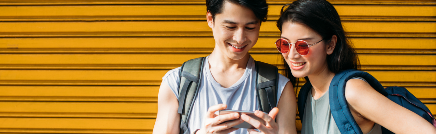 Two people looking at a smartphone
