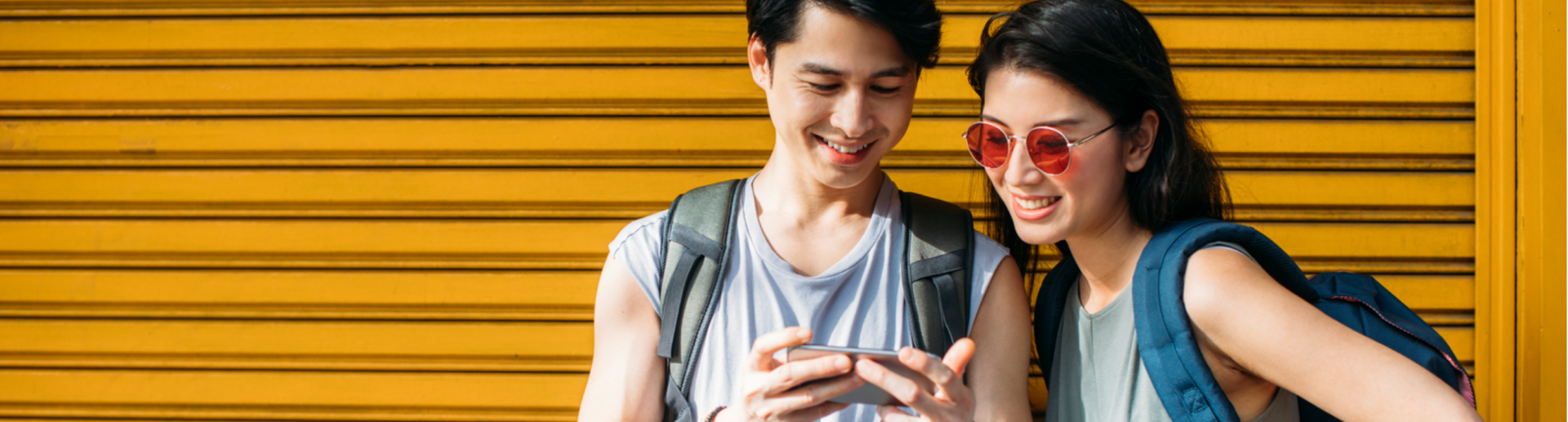 Two people looking at a smartphone