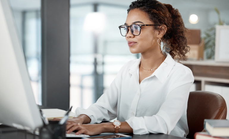 Woman with glasses using her computer