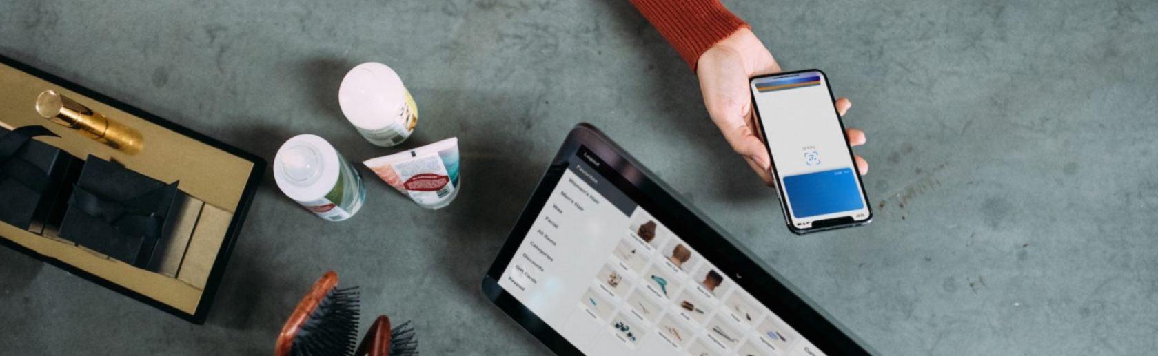 Someone holding out their smartphone to pay for a purchase