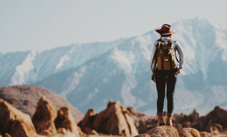 A celebratory photo of a woman on a hike for Women's History Month